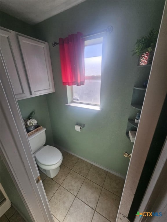 bathroom with tile patterned floors and toilet