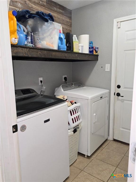 2301 Jake Dr, Copperas Cove, TX 76522 - laundry area featuring washer and clothes dryer and light tile patterned flooring