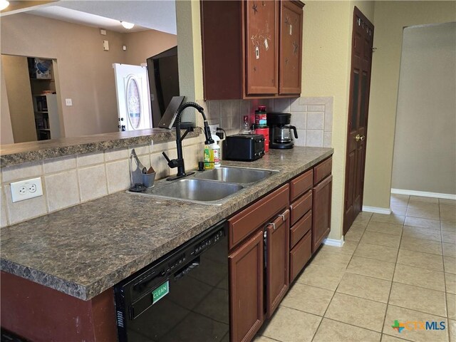 2301 Jake Dr, Copperas Cove, TX 76522 - kitchen featuring black dishwasher, a sink, tasteful backsplash, and dark countertops