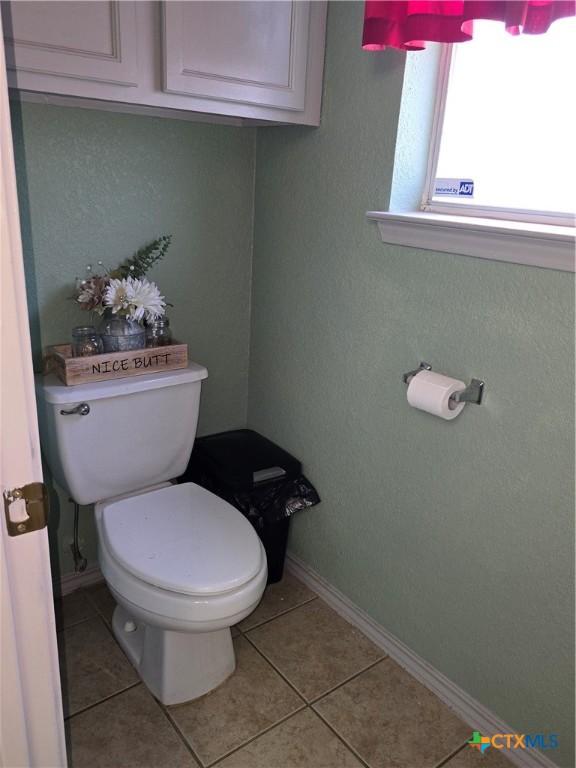2301 Jake Dr, Copperas Cove, TX 76522 - bathroom featuring baseboards, toilet, and tile patterned flooring