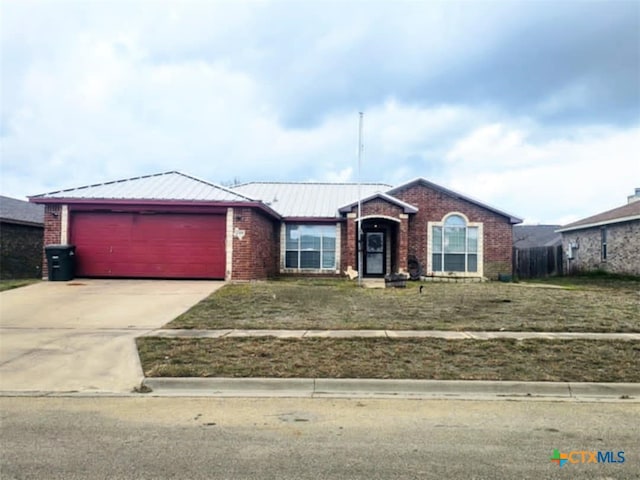 single story home featuring a front lawn and a garage