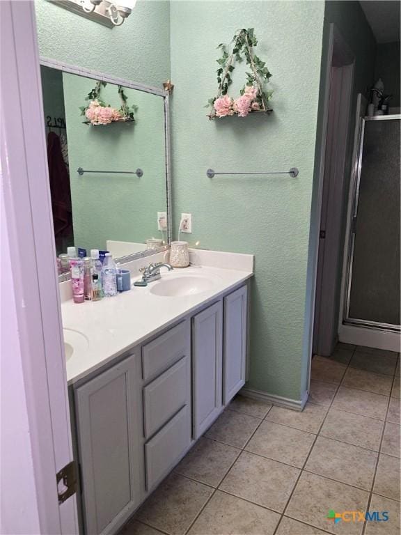 2301 Jake Dr, Copperas Cove, TX 76522 - bathroom with tile patterned floors, double vanity, and a textured wall