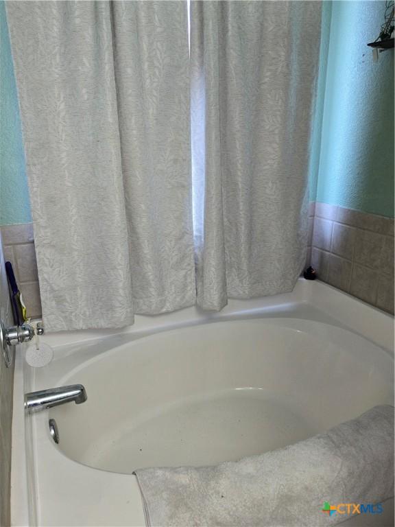 2301 Jake Dr, Copperas Cove, TX 76522 - full bath with a bath and a textured wall