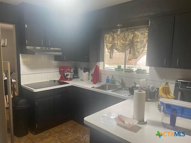 kitchen with sink, backsplash, and black electric stovetop