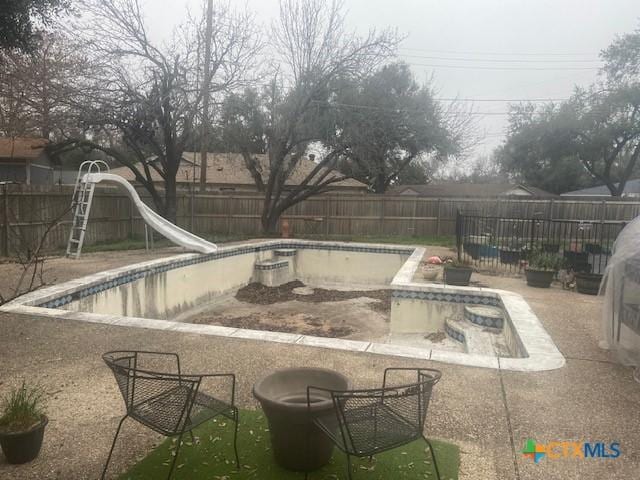 view of swimming pool with a water slide