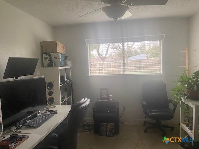 office with ceiling fan and a textured ceiling