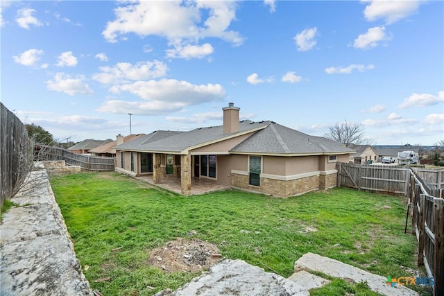 back of property featuring a lawn, a chimney, a fenced backyard, and stucco siding