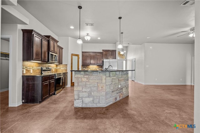 kitchen with stainless steel appliances, tasteful backsplash, and concrete floors