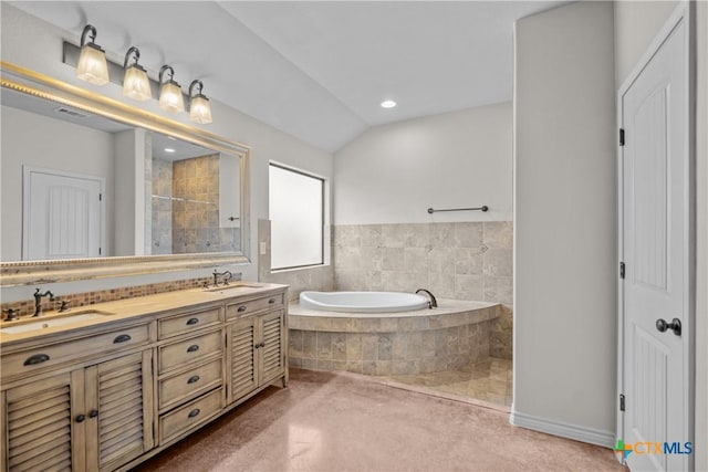 bathroom with vaulted ceiling, tiled shower, a sink, and a bath