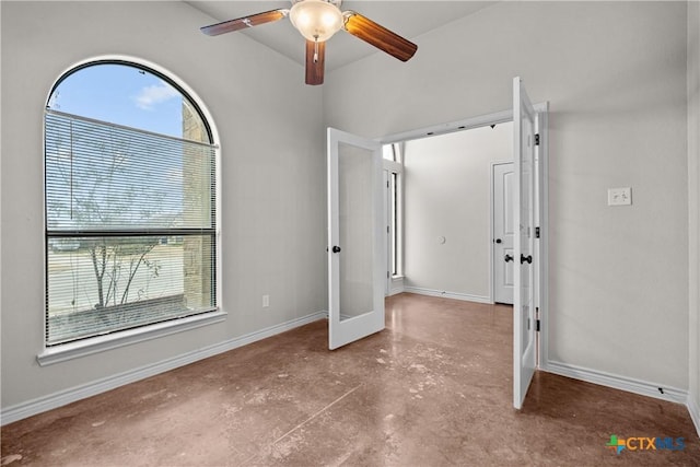 unfurnished bedroom featuring a ceiling fan, french doors, concrete floors, and baseboards