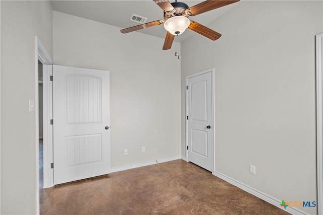 unfurnished bedroom featuring baseboards, concrete floors, visible vents, and ceiling fan