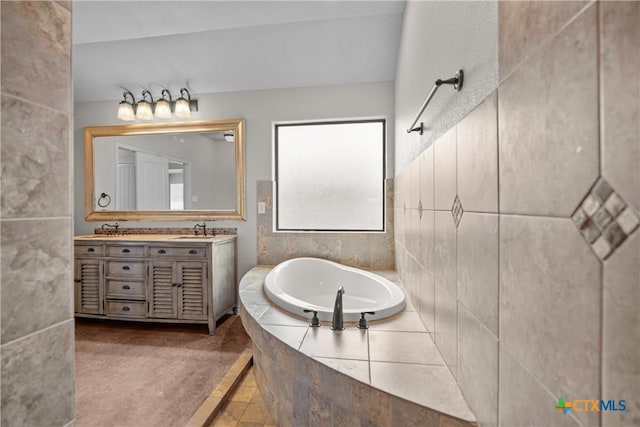 bathroom with a garden tub, double vanity, and a sink