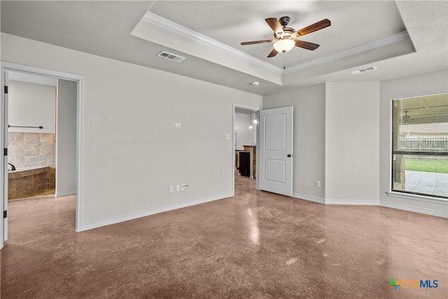 spare room with baseboards, visible vents, and a raised ceiling