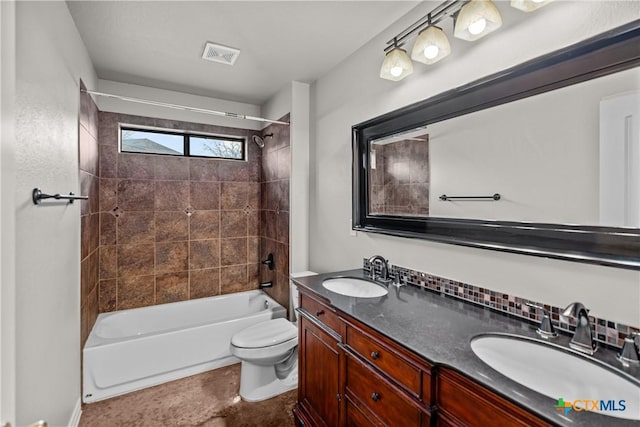 full bathroom with visible vents, double vanity, a sink, and toilet