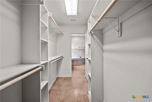 spacious closet featuring visible vents