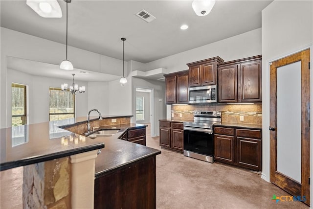 kitchen with stainless steel appliances, a wealth of natural light, visible vents, backsplash, and a sink