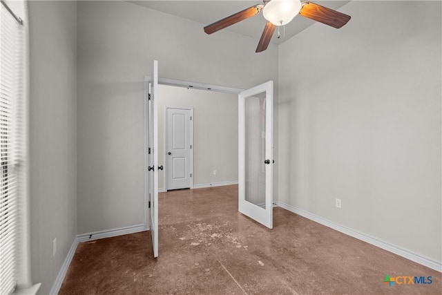 unfurnished bedroom featuring concrete flooring, french doors, baseboards, and a ceiling fan