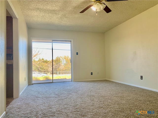 carpeted empty room with ceiling fan and a textured ceiling