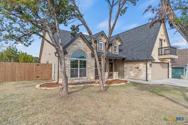 view of front of property with a front lawn, a garage, and a balcony