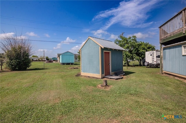 view of outbuilding featuring a yard