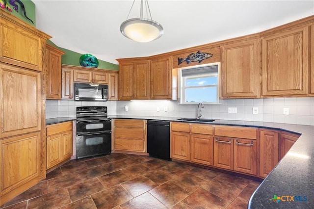 kitchen with pendant lighting, sink, decorative backsplash, and black appliances