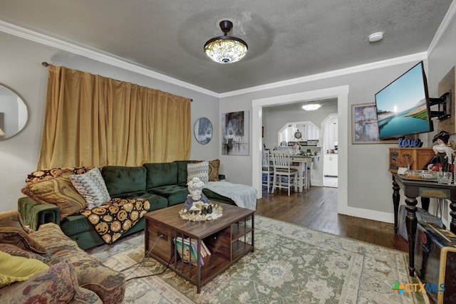 living room featuring ornamental molding, dark wood-type flooring, and a textured ceiling