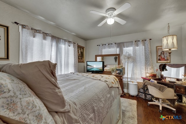 bedroom with ceiling fan and dark hardwood / wood-style flooring