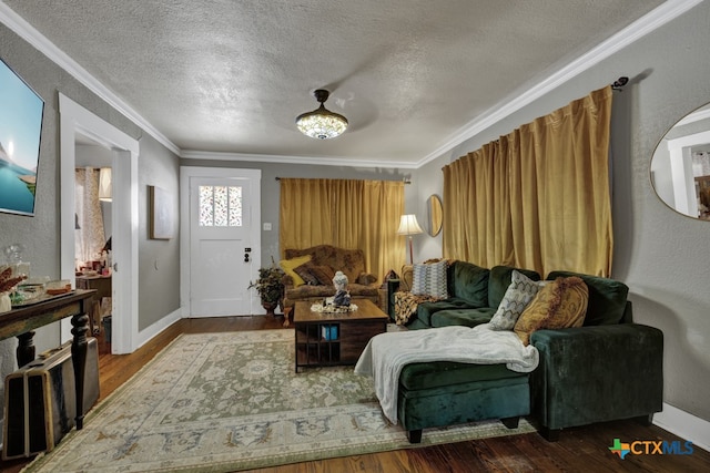 living room featuring wood-type flooring, a textured ceiling, and crown molding