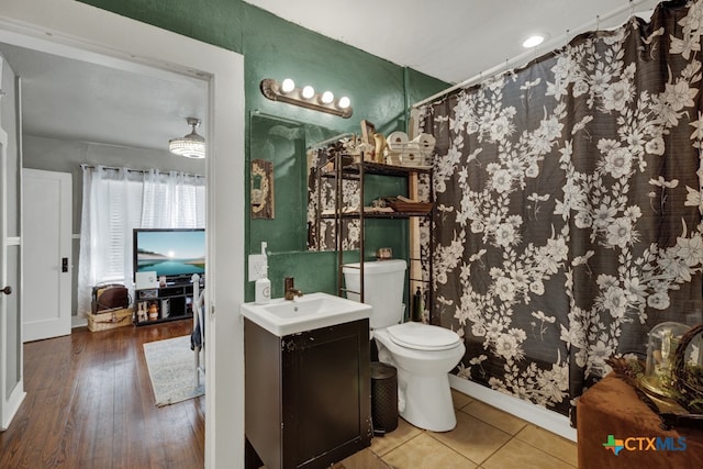 bathroom featuring toilet, vanity, and hardwood / wood-style flooring