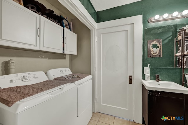 laundry room featuring washer and clothes dryer, sink, and light tile patterned floors