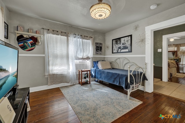 bedroom featuring dark hardwood / wood-style flooring and cooling unit