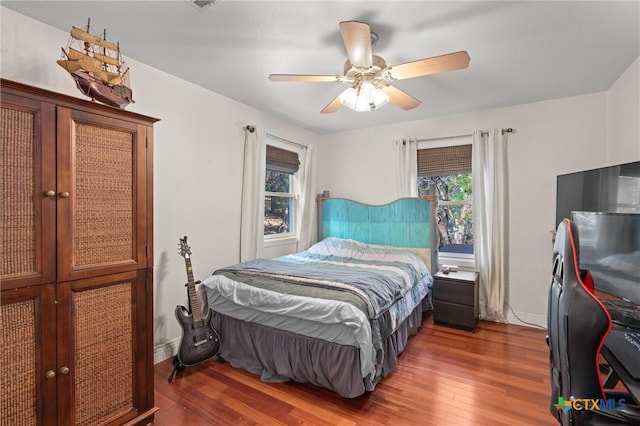 18917 Peckham Dr, Lago Vista, TX 78645 - bedroom with multiple windows, wood finished floors, and ceiling fan