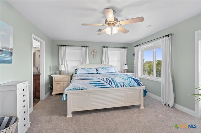 18917 Peckham Dr, Lago Vista, TX 78645 - bedroom with light carpet, a ceiling fan, and connected bathroom