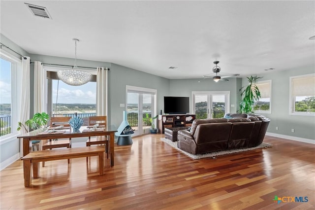 18917 Peckham Dr, Lago Vista, TX 78645 - living room featuring wood finished floors, ceiling fan, and a chandelier