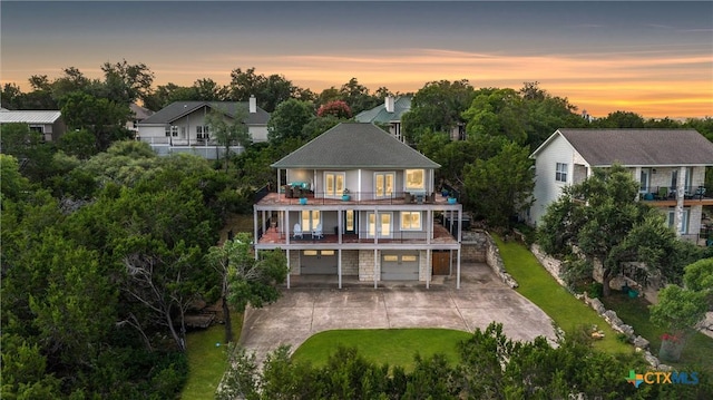 18917 Peckham Dr, Lago Vista, TX 78645 - back of property with a balcony, a garage, driveway, and a lawn