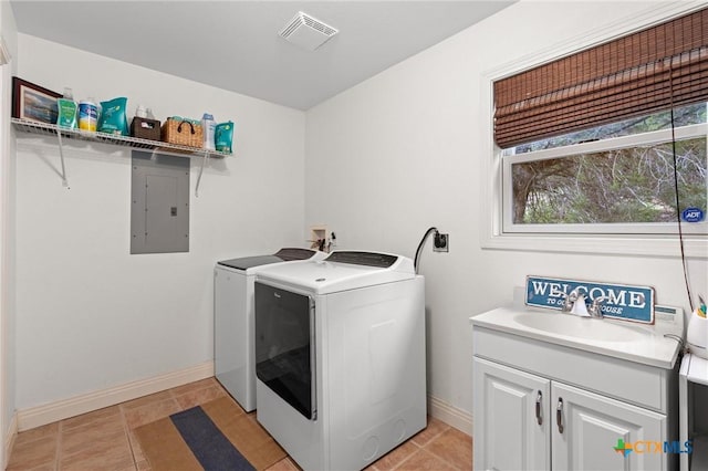 18917 Peckham Dr, Lago Vista, TX 78645 - washroom featuring electric panel, washing machine and clothes dryer, cabinet space, and light tile patterned floors
