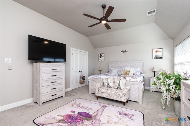 carpeted bedroom with ceiling fan and vaulted ceiling