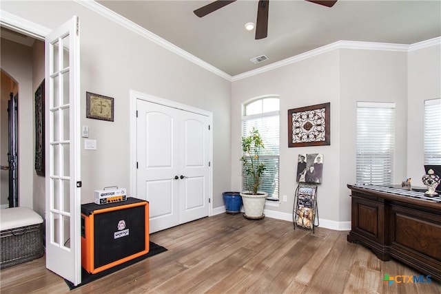 entryway with hardwood / wood-style floors, french doors, and ornamental molding