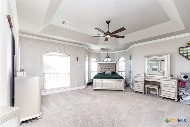 carpeted bedroom featuring ceiling fan, a raised ceiling, and crown molding