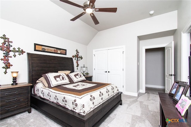 carpeted bedroom featuring a closet, vaulted ceiling, and ceiling fan