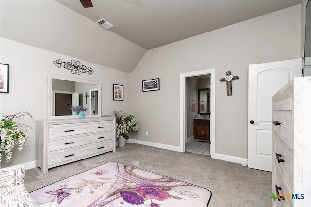 bedroom with connected bathroom, light colored carpet, ceiling fan, and lofted ceiling