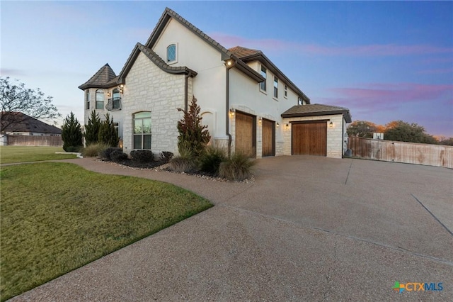 property exterior at dusk featuring a yard