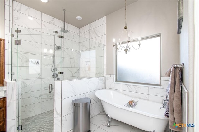 bathroom with tile walls and independent shower and bath