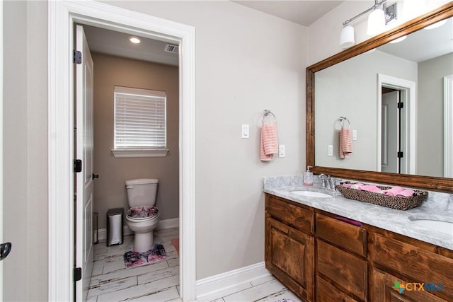 bathroom with vanity and toilet