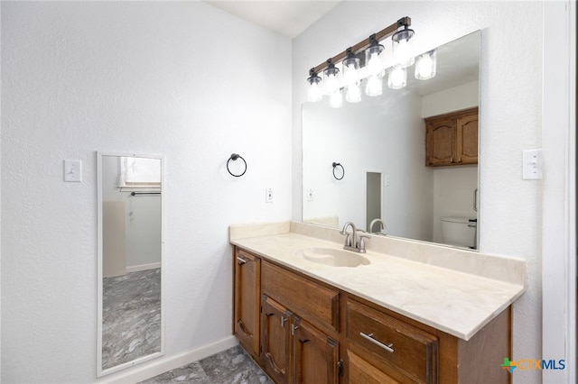 bathroom featuring vanity and toilet