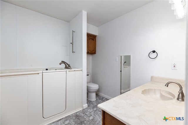 bathroom featuring vanity and toilet