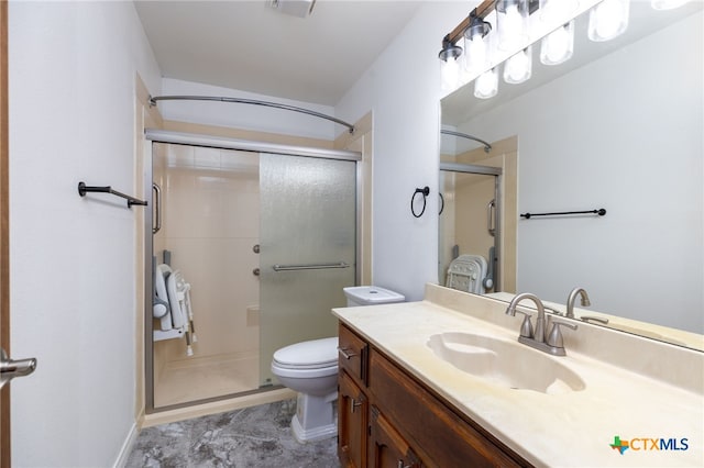 bathroom featuring vanity, toilet, and a shower with door