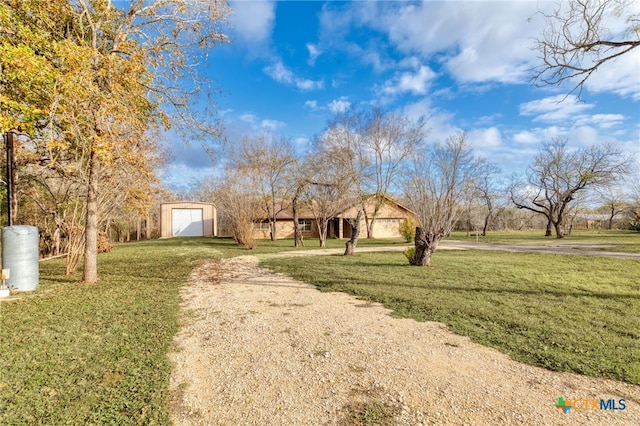 view of yard with a garage and an outdoor structure