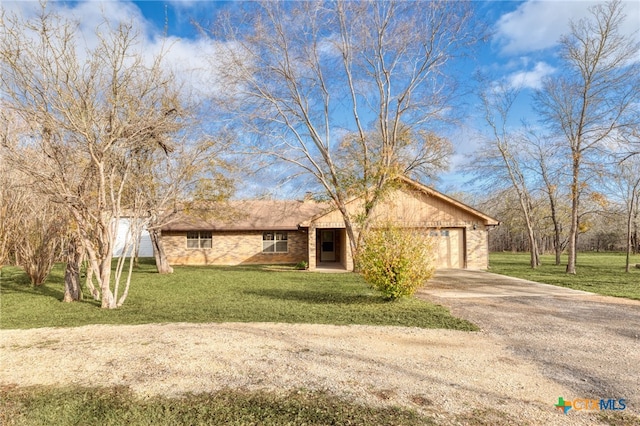 ranch-style house featuring a front yard and a garage