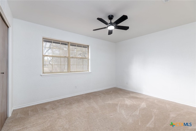 empty room featuring light carpet and ceiling fan